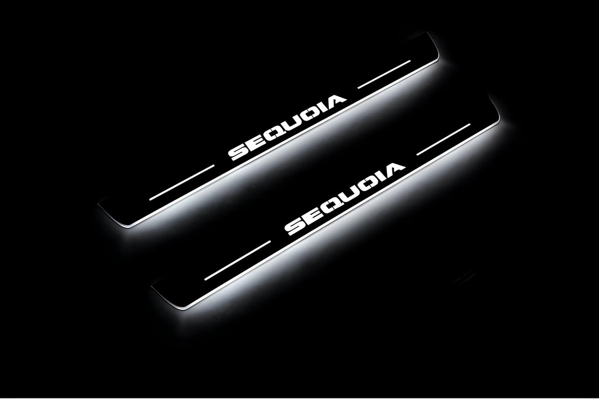 Two short door sill plates with Sequoia lettering and edges illuminated in white, angled view on a dark background.