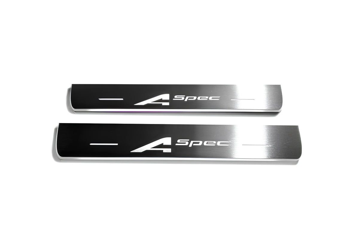 Two short silver-finished door sill plates with A-Spec lettering on a light background, straight-on view.