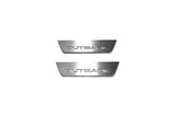 Two short silver-finished door sill plates with Outback lettering on a light background, straight-on view.