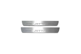 Two short silver-finished door sill plates with Jetta lettering on a light background, straight-on view.