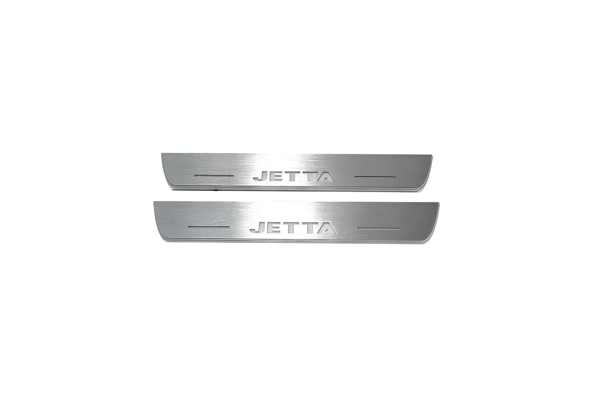 Two short silver-finished door sill plates with Jetta lettering on a light background, straight-on view.