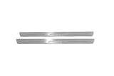 Two long silver-finished door sill plates with Auris lettering on a light background, straight-on view.