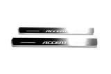 Two long silver-finished door sill plates with Accent lettering on a light background, straight-on view.