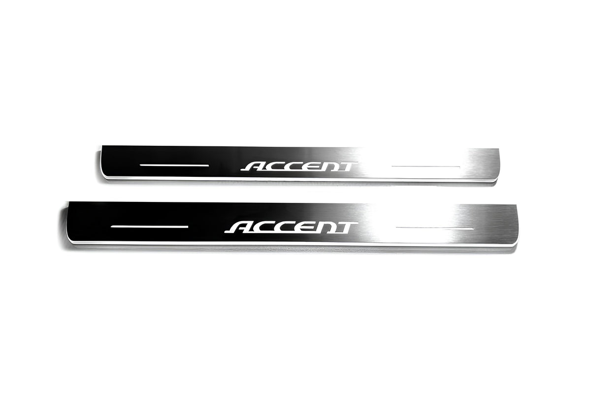 Two long silver-finished door sill plates with Accent lettering on a light background, straight-on view.