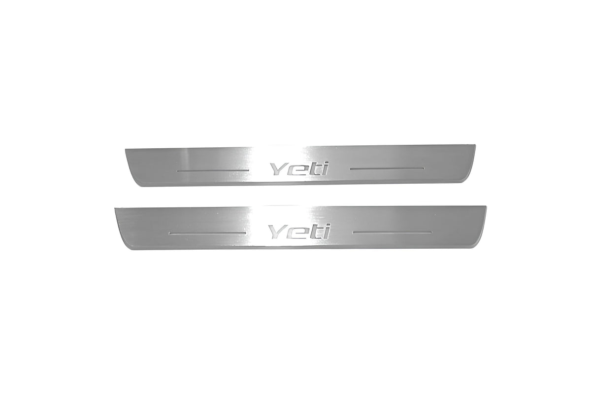 Two long silver-finished door sill plates with Yeti lettering on a light background, straight-on view.