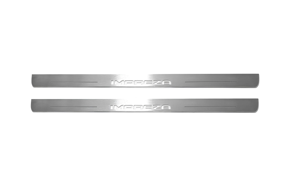 Two long silver-finished door sill plates with Impreza lettering on a light background, straight-on view.