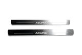 Two long reflective dark door sill plates with white Acura lettering and horizontal lines on a white background, straight-on view.