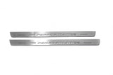 Two long silver-finished door sill plates with M Performance lettering on a light background, straight-on view.