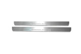 Two long silver-finished door sill plates with Grandland X lettering on a light background, straight-on view.