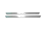 Two long silver-finished door sill plates with ID.4 lettering on a light background, straight-on view.