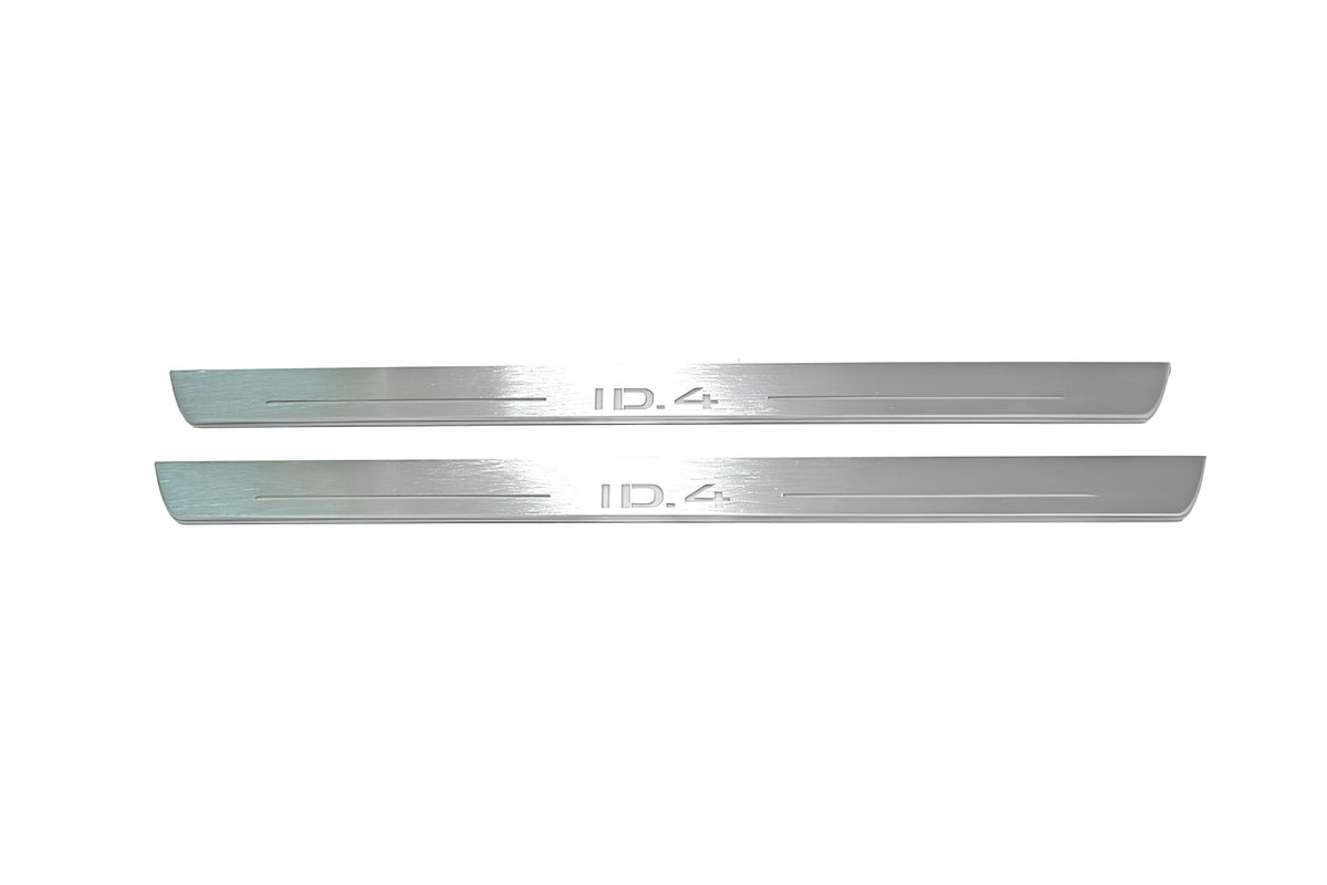 Two long silver-finished door sill plates with ID.4 lettering on a light background, straight-on view.