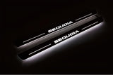 Two long door sill plates with Sequoia lettering and edges illuminated in white, angled view on a dark background.