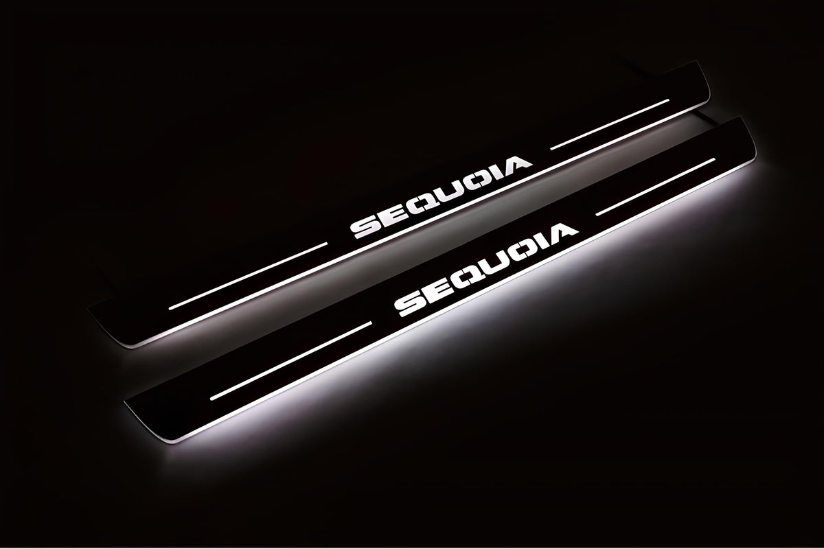 Two long door sill plates with Sequoia lettering and edges illuminated in white, angled view on a dark background.