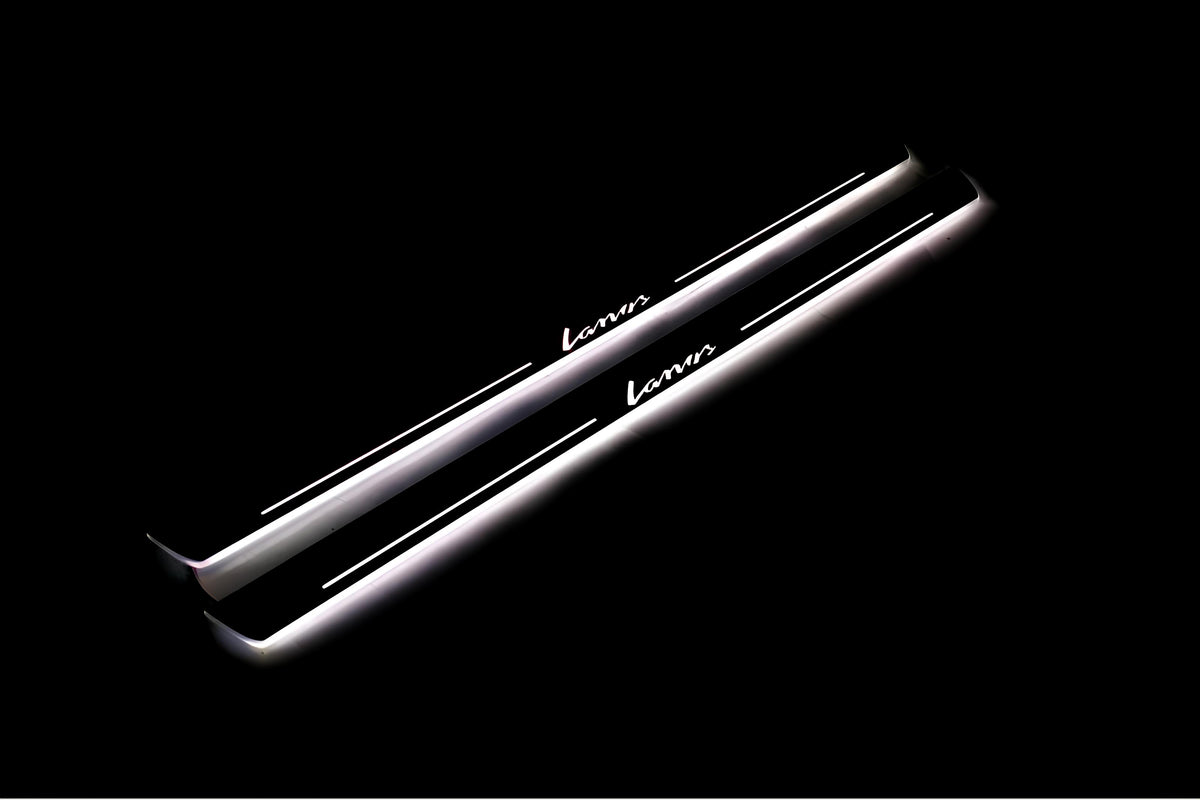 Two long door sill plates with Lanos lettering and edges illuminated in white, angled view on a dark background.