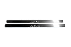 Two long silver-finished door sill plates with Audi A5 lettering on a light background, straight-on view.