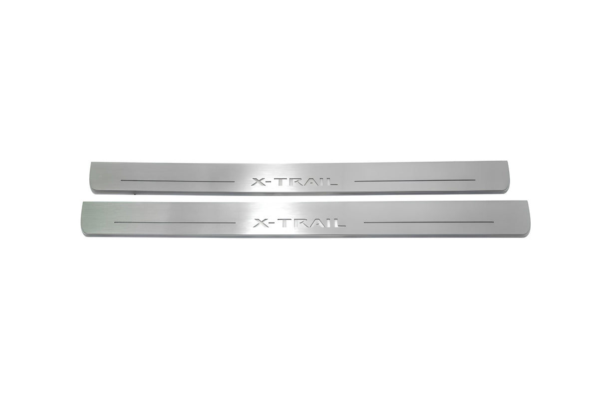 Two long silver-finished door sill plates with X-Trail lettering on a light background, straight-on view.