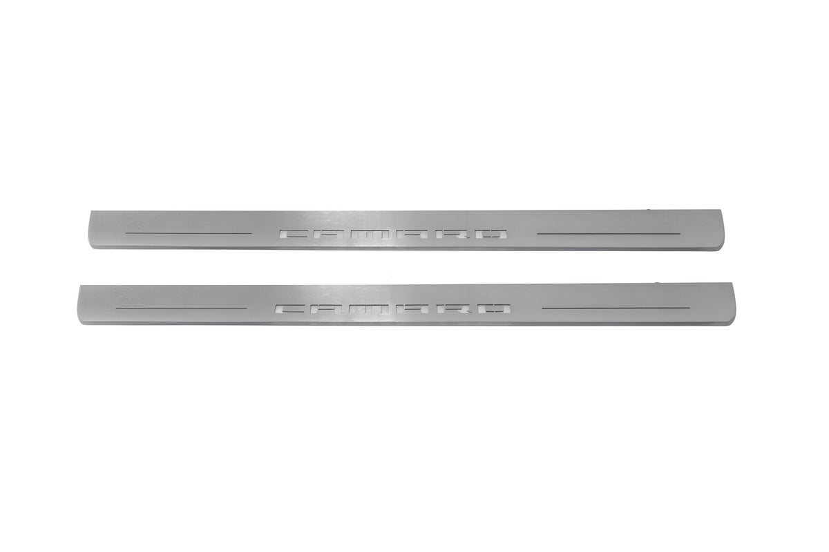 Two long silver-finished door sill plates with Camaro lettering on a light background, straight-on view.