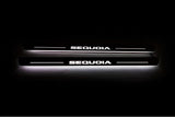 Two long door sill plates with Sequoia lettering and edges illuminated in white, straight-on view on a dark background.