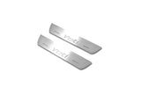 Two short silver-finished door sill plates with Yeti lettering on a light background, angled view.