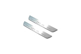 Two short silver-finished door sill plates with ID.4 lettering on a light background, angled view.