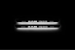Two short door sill plates with RAM 1500 lettering and edges illuminated in white, straight-on view on a dark background.
