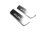Two short reflective dark door sill plates with white Acura lettering on a white background, angled view.