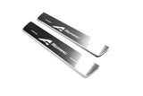 Two short silver-finished door sill plates with A-Spec lettering on a light background, angled view.