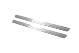 Two long silver-finished door sill plates with Impreza lettering on a light background, angled view.