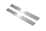 Two long silver-finished door sill plates with MDX lettering on a light background, angled view.