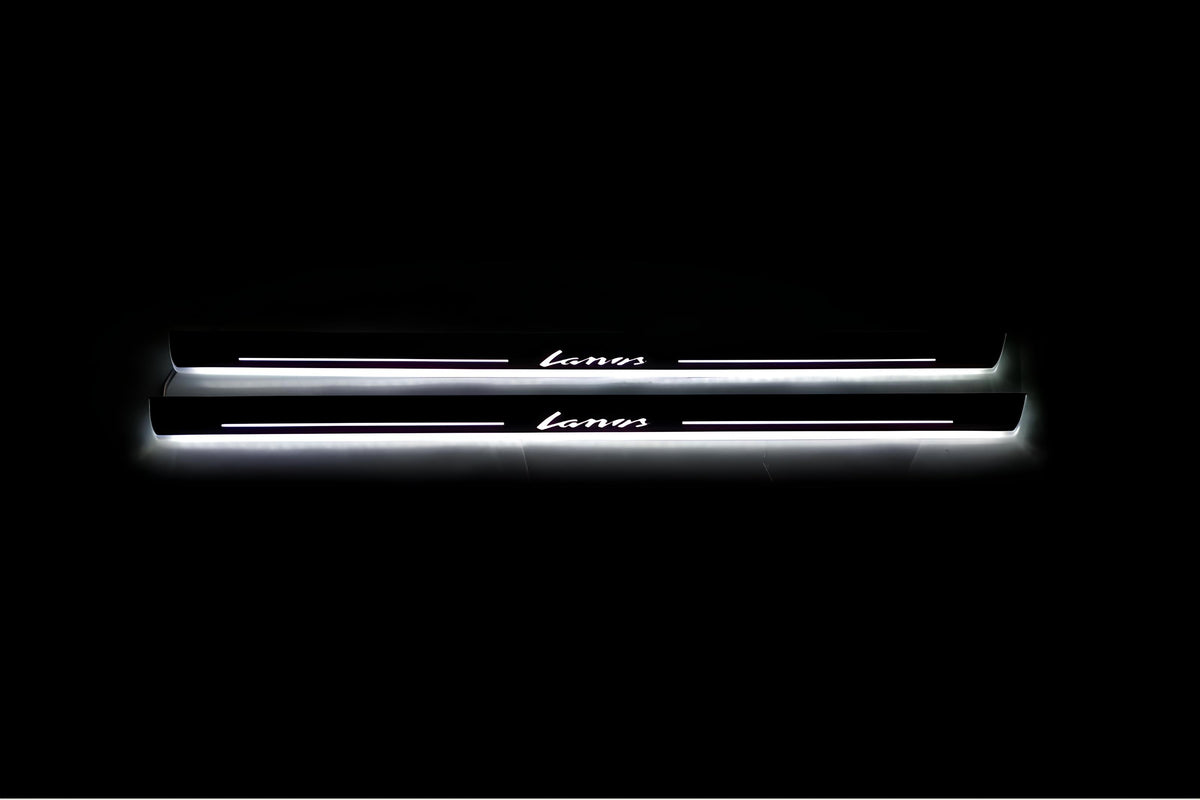 Two long door sill plates with Lanos lettering and edges illuminated in white, straight-on view on a dark background.