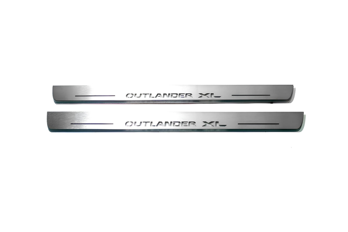 Two long silver-finished door sill plates with Outlander XL lettering on a light background, straight-on view.