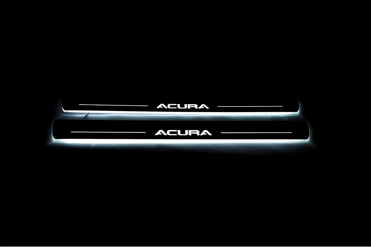 Two long door sill plates with Acura lettering and edges illuminated in white, straight-on view on a dark background.
