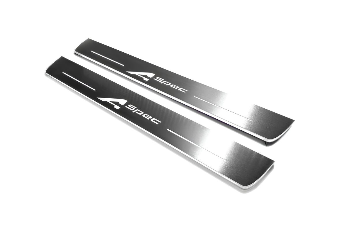 Two long silver-finished door sill plates with A-Spec lettering on a light background, angled view.