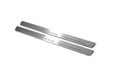 Two long silver-finished door sill plates with Jetta lettering on a light background, angled view.