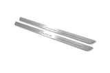 Two long silver-finished door sill plates with Juke lettering on a light background, angled view.