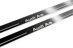 Close-up of Audi A5 lettering and linear slots in silver-finished door sill plates.