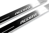 Close-up of Accent lettering and linear slots in silver-finished door sill plates.