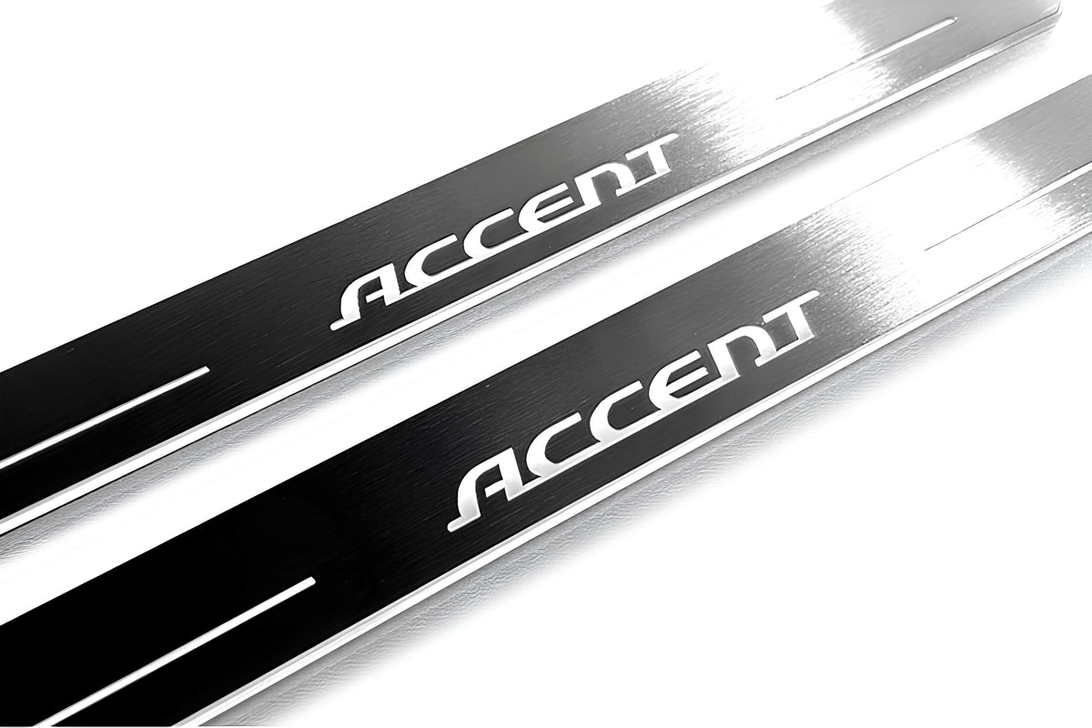 Close-up of Accent lettering and linear slots in silver-finished door sill plates.