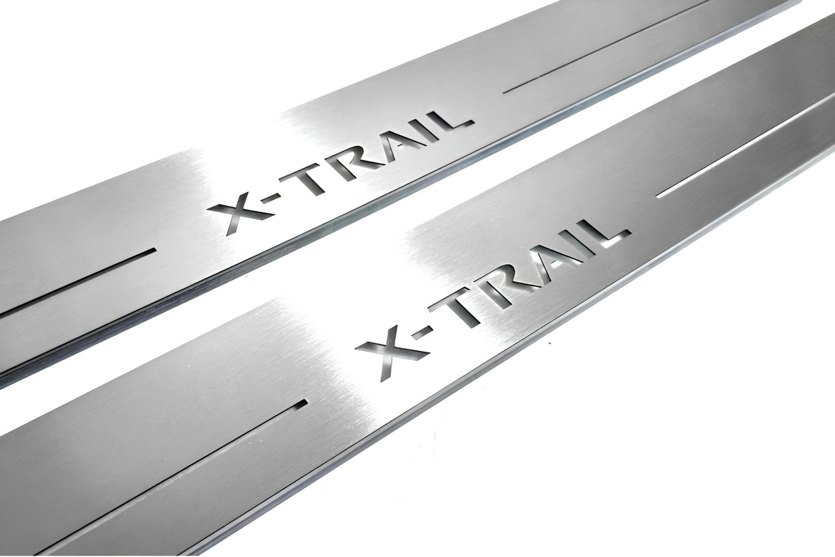 Close-up of X-Trail lettering and linear slots in silver-finished door sill plates.