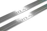 Close-up of ID.4 lettering and linear slots in silver-finished door sill plates.