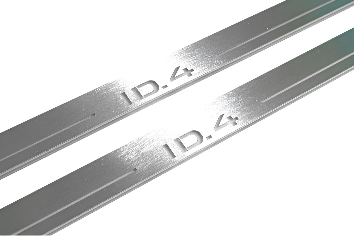 Close-up of ID.4 lettering and linear slots in silver-finished door sill plates.