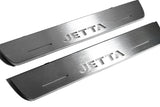Close-up of Jetta lettering and linear slots in silver-finished door sill plates.