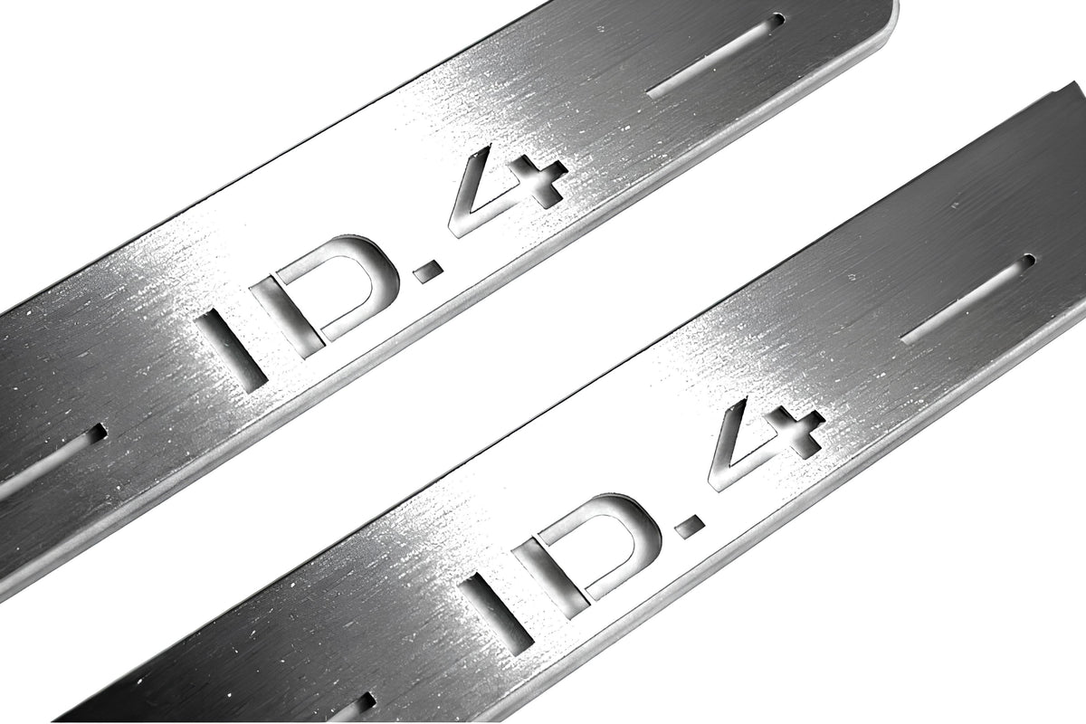 Close-up of ID.4 lettering and linear slots in silver-finished door sill plates.