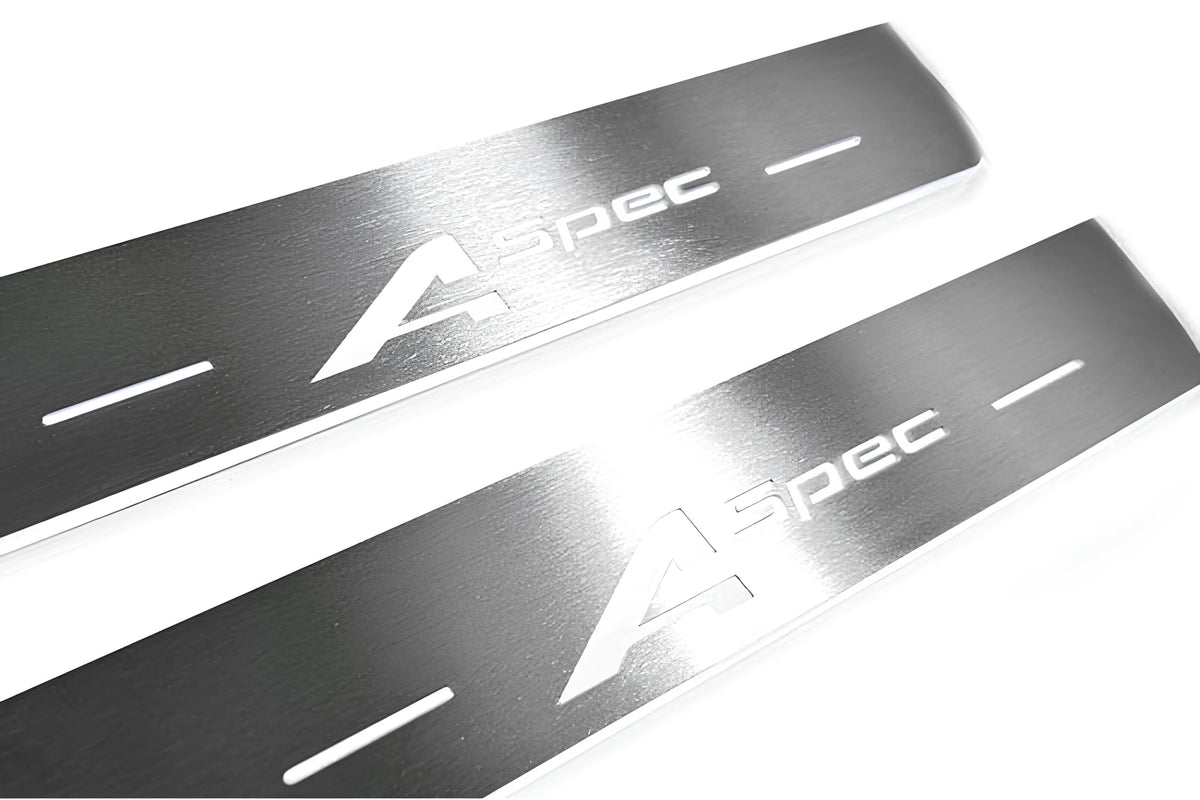 Close-up of A-Spec lettering and linear slots in silver-finished door sill plates.