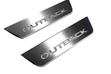 Close-up of Outback lettering and linear slots in silver-finished door sill plates.