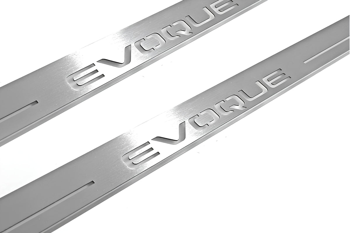 Close-up of Evoque lettering and linear slots in silver-finished door sill plates.