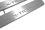 Close-up of X-Trail lettering and linear slots in silver-finished door sill plates.