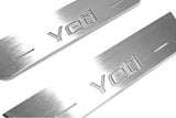 Close-up of Yeti lettering and linear slots in silver-finished door sill plates.