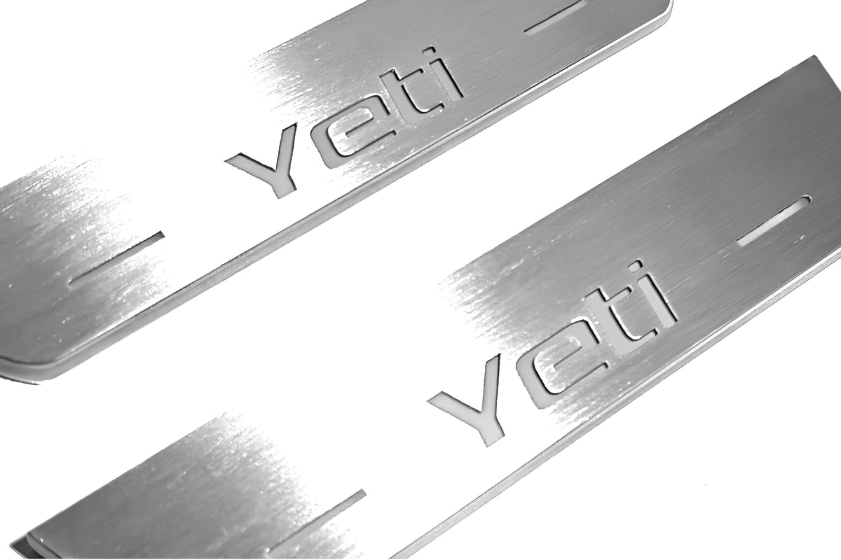 Close-up of Yeti lettering and linear slots in silver-finished door sill plates.