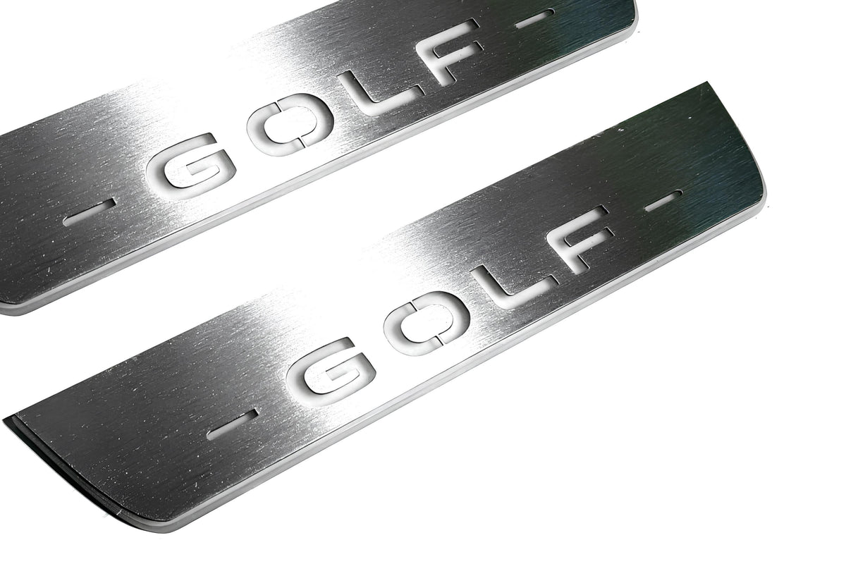 Close-up of Golf lettering and linear slots in silver-finished door sill plates.